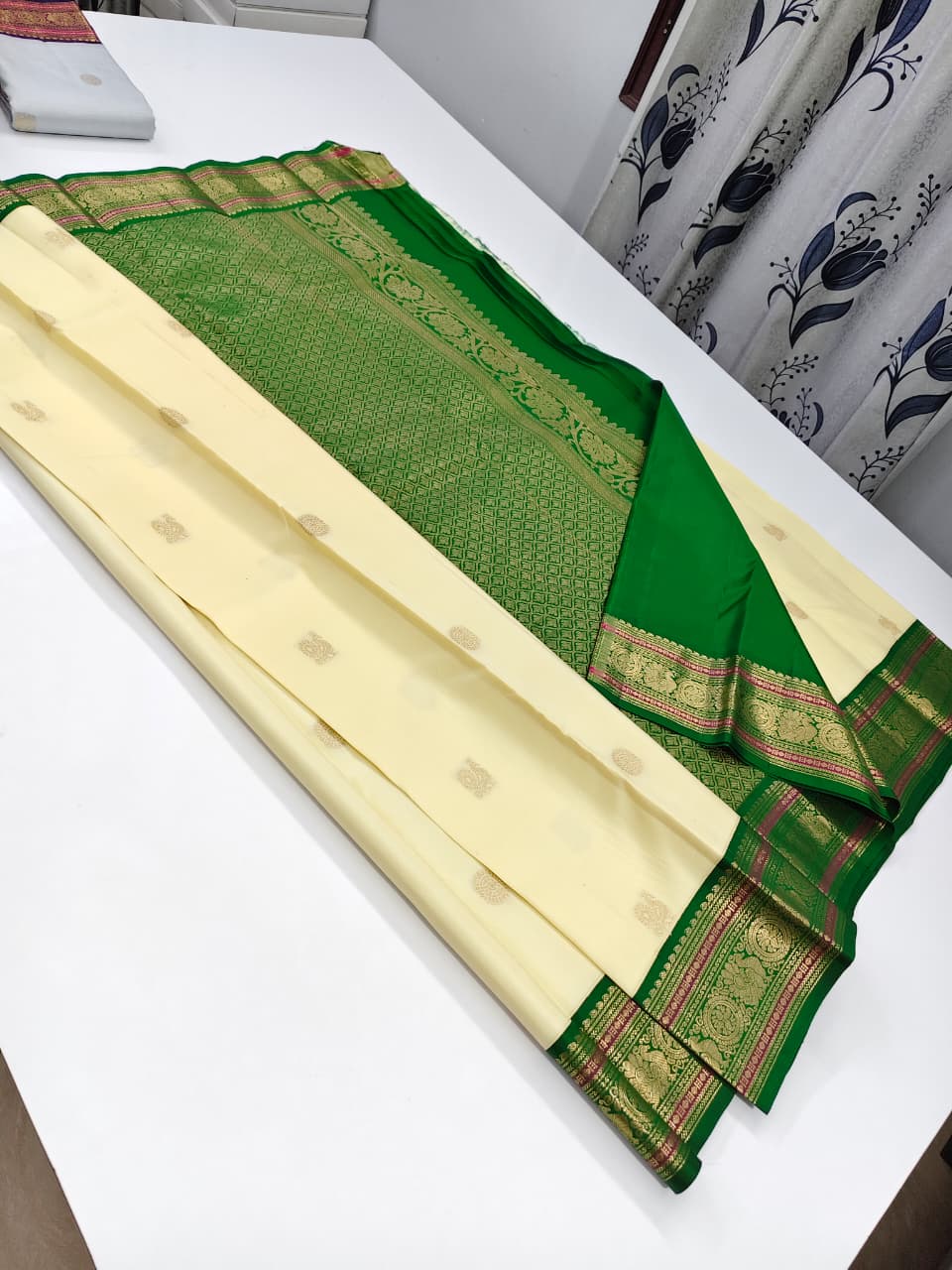 Handloom Kanchipuram Silk Saree with a traditional contrast border and buttas.